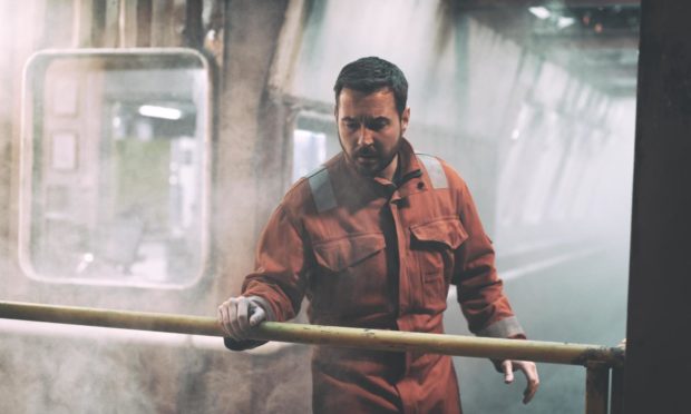 Martin Compston's character working on an oil rig in Amazon's thriller The Rig.