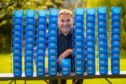 Mary's Meals founder Magnus MacFarlane Barrow with the mugs that serve the meals