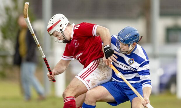 Finlay Macrae (Kinlochshiel) battles with Iain Robinson (Newtonmore).