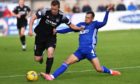 Cove Rangers' Connor Scully tackles Peterhead captain Scott Brown.