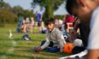 Recently arrived Afghan citizen Adbullah watches on from the boundary as his father takes part in a cricket match with members of Newport Pagnell Town Cricket Club in Buckinghamshire, organised by the club as a gesture to welcome them to the UK.  Picture by PA.