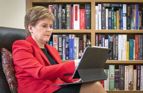 First Minister Nicola Sturgeon at her home in Glasgow preparing her speech for the SNP National Conference (Photo: PA)