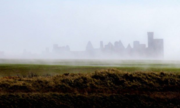 Slains Castle is a ghostly site in the haar.