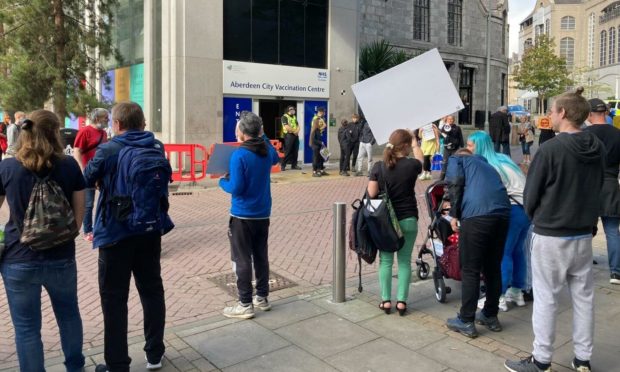 Anti-vaccination protesters outside the former John Lewis in Aberdeen.