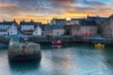 Airbnb is helping tourism recovery in Scotland post-Covid - and you can too. Sunset at Portsoy harbour.