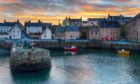 Airbnb is helping tourism recovery in Scotland post-Covid - and you can too. Sunset at Portsoy harbour.