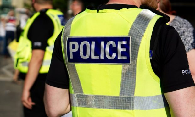 A police officer in a high-vis vest.