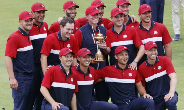 The United States team celebrates with the Ryder Cup.