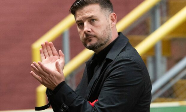 Dundee United manager Tam Courts held up a 'show racism the red card' T-shirt at full-time.
