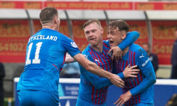 Inverness players congratulate Billy Mckay, centre, for their first goal at Elgin.