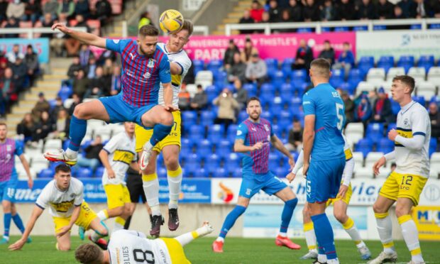 Caley Jags defender Danny Devine takes to the air against Morton.