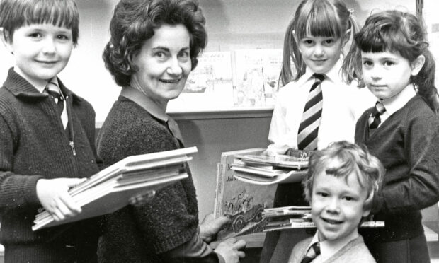 1982 - P1 and P2 pupils of Balmedie Primary School helping head teacher Lilian Youngson with books in the new library are, from left, Steven Masson, Marissa Carrara, Rodney McKnight and Louise Stewart