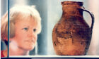 1996 - Keeper of archaeology Judith Stones examines the King Street Pot, which dates from the mid-13th century, and was on display in the centre court at Aberdeen Art Gallery