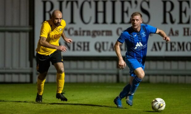 Kris Duncan, of Strathspey, on the attack.