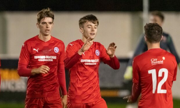 Gregor MacDonald (centre) celebrates netting for Brora Rangers.