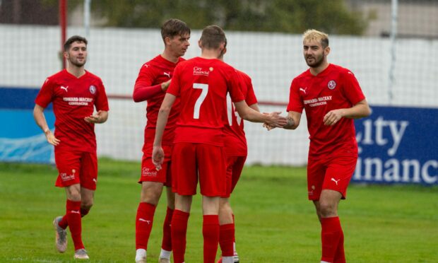 The Brora players celebrate their first goal against Strathspey Thistle