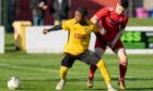 Blessings Tshibkubula of Fort William, left, tries to fend off Lossiemouth's Lewis Mcandrew
