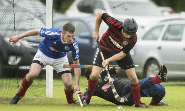 Oban’s Andrew MacCuish worries the Kyles defence of Callum Millar and keeper John Whyte, during the 2017 Celtic Society Cup Final at Taynuilt.