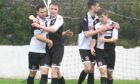 Sunnybank's Dean Still, far left, is congratulated by Jack Craigie after scoring the opening goal against Longside. Picture by Chris Sumner.