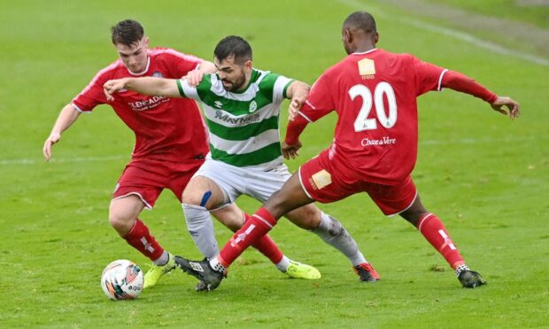 Brechin's Kieran Inglis and Julian Wade close in on Buckie's Andrew MacAskill.