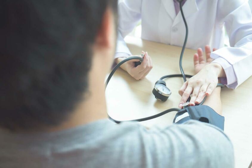 Doctor checking person's heart rate.
