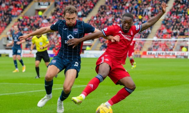 Aberdeen's Austin Samuels and Ross County's Connor Randall in action