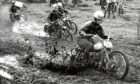 1962: The mud goes flying into the air during a motorcycle race at Newburgh.
