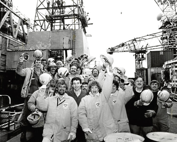 1984: Workers on BP’s Forties Alpha production platform are joined by celebrities Noel Edmonds and Barbara Dickson.