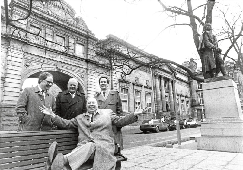 1992: Another picture of the four men at the Schoolhill Pocket Park, as Mr Middleton tries one of the benches in the park.
