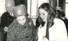 1970: The Queen attended Hazlehead Academy for its official opening. Third year pupil Linda Williamson explains techniques of design to the Queen in the art department.