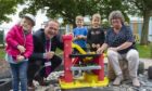 Laurence Findlay, Aberdeenshire Council's director of education and Gillian Owen, education committee chairwoman, with children at the new Fishermoss School nursery.