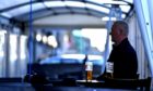 A customer enjoys a pint in the The Grill's tent in Union Street.