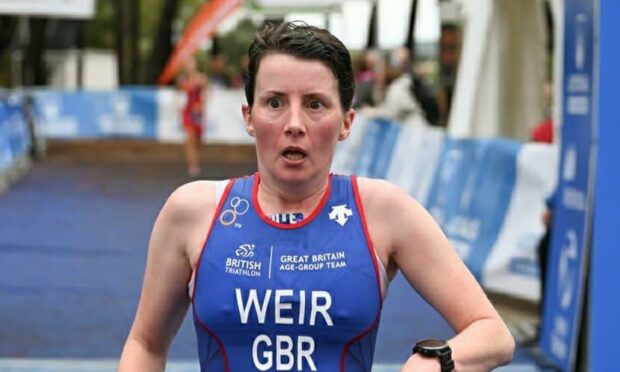 Sandra Weir in shock as she crosses the finish line of the World Aquathlon Championships
