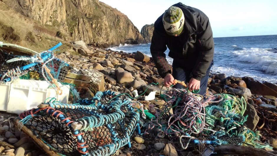 Allan Sinclair clearing up netting from a Caithness beach,