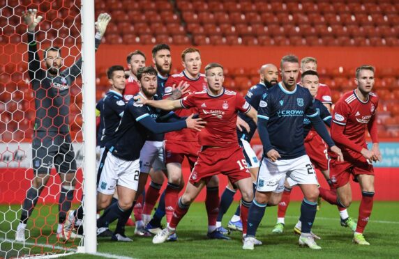 Aberdeen and Dundee players jostle for position at Pittodrie