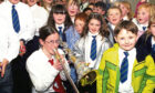 1999 - A trombonist, with her instrument suitably decorated, plays for the younger children