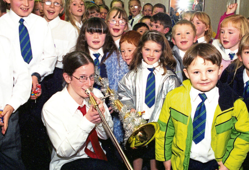 1999 - A trombonist, with her instrument suitably decorated, plays for the younger children
