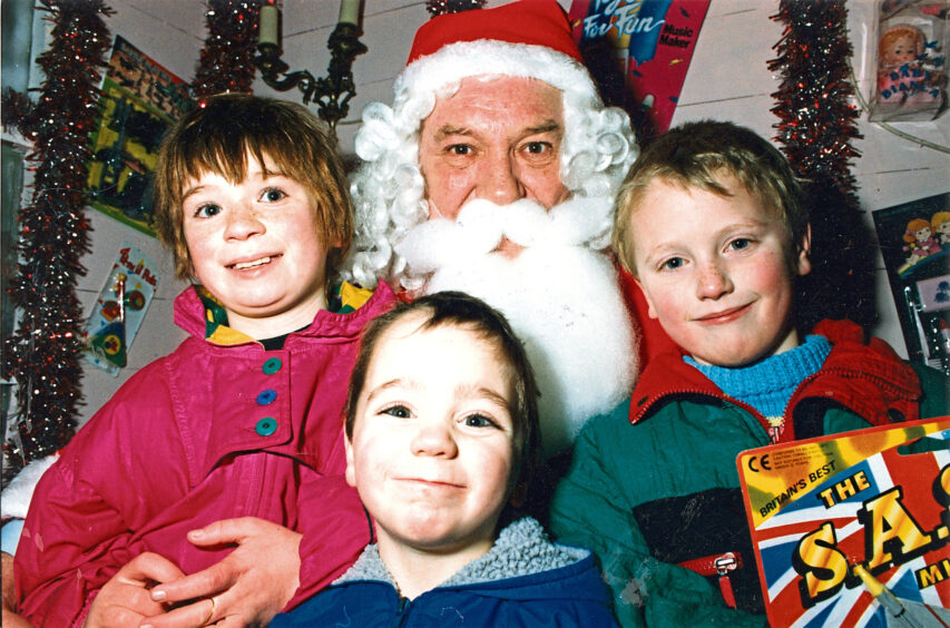 1990 - Diane Henderson, 10, her brother Christopher, 4, and Shaun Cowie, 7, pay a visit to Santa