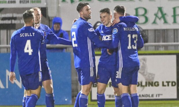Robbie Leitch celebrates with Cove teammates after scoring their fourth goal. Pic by Chris Sumner.