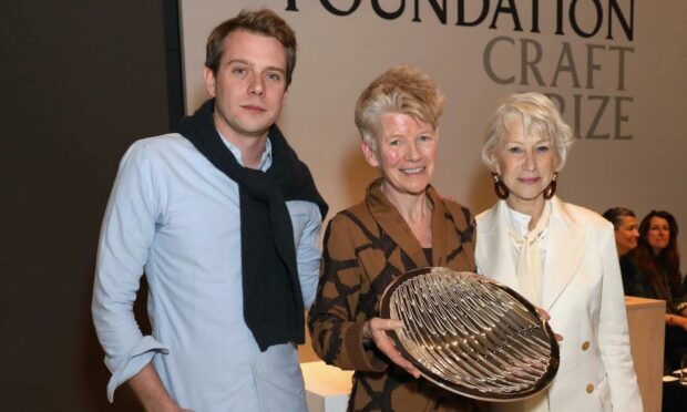 Jennifer Lee receives her Loewe Craft Prize from Dame Helen Mirren, with Jonathan Anderson, Loewe creative director, at The Design Museum in London in 2018.
