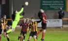 Huntly goalkeeper Tom Ritchie punches the ball clear against Inverurie Locos