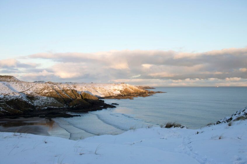 A snowy view of Hackley Bay - one of the best coastal walks in Aberdeenshire