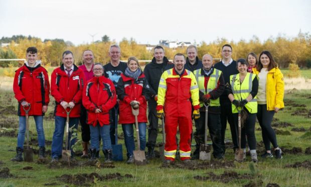 Seaton Primary School pupils and North Star's Anita Campbell planting trees in the new woodland area being created next to the school as part of North Star's sustainability programme.
