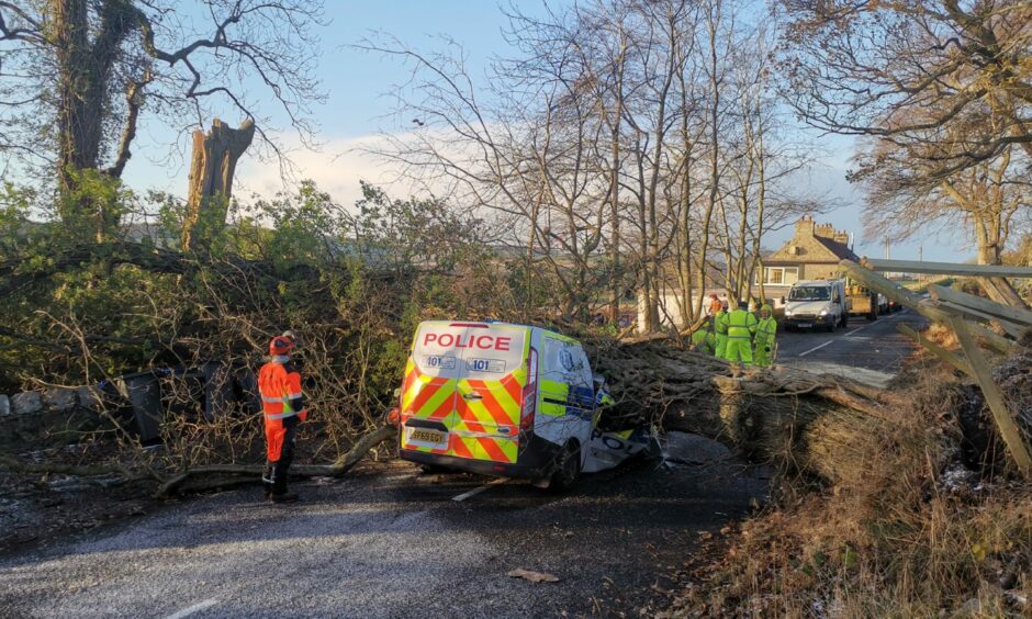 A police car was hit by a falling tree during Storm Arwen at Hatton Of Fintray in Aberdeenshire. Picture by Kenny Elrick/DCT Media.