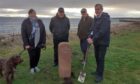 Sandy Mackay of Golspie cuts the turf for a battlefield trail marker post with Shirley Sutherland. of Golspie Heritage Society, John Melville, society chairman and  project leader Patrick Marriott.