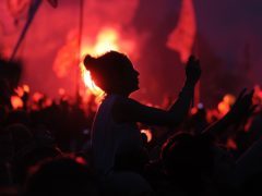 Flares in the crowd as the Rolling Stones perform on the Pyramid Stage during the Glastonbury 2013 Festival at Pilton Farm, Somerset.