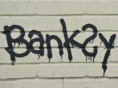 A Banksy signature on a mural (PA)