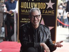 Actor Jeff Goldblum, best known for his roles in Independence Day and Jurassic Park, poses atop his star on the Hollywood Walk of Fame (Chris Pizzello/Invision/AP)