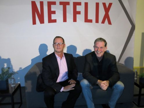 Reed Hastings, CEO and founder of Netflix, right, sits with Jonathan Friedland (Berenice Bautista/AP)