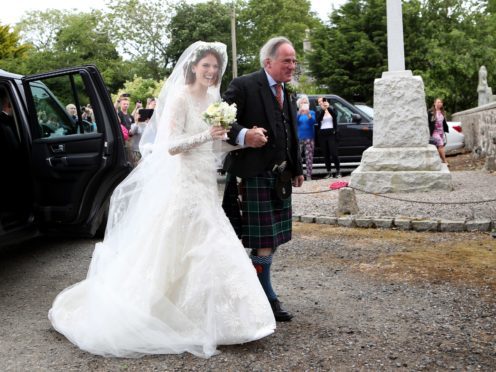 Rose Leslie with her father Sebastian Leslie arrive at Rayne Church, Kirkton of Rayne in Aberdeenshire, for her wedding (Jane Barlow/PA)